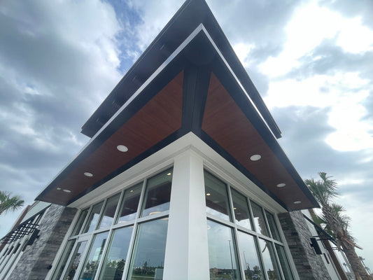 Woodgrain aluminum canopy soffit on a commercial entrance