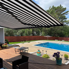 Outdoor patio with striped awning, pool, and garden furniture